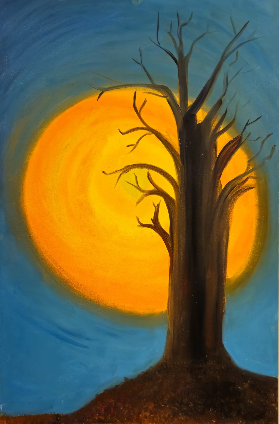 A bare tree silhouetted against a large glowing moon